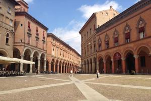 a group of buildings with people walking through a street at Casa 28 in Bologna