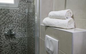a bathroom with towels on a counter next to a shower at Villa Lajna in Neum +31 photos
