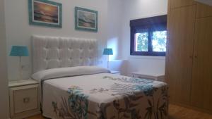 a bedroom with a bed and a window at Casa A Veiga in O Grove