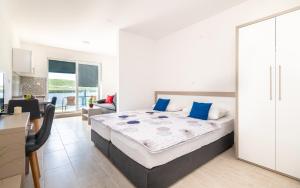 a bedroom with a large bed with blue pillows at Villa Lajna in Neum