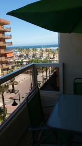 a balcony with a table and a view of a beach at Apartment PYR in Fuengirola