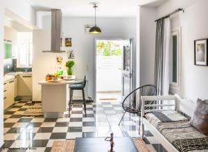 a kitchen and living room with a checkered floor at Chessboard decor House in Kamari