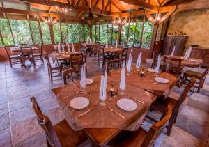 a dining room with wooden tables and chairs at Hotel El Silencio del Campo in Fortuna