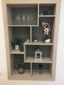 a book shelf with vases and plants in it at Apartment Bacvice in Split