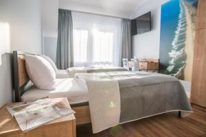 Łóżko lub łóżka w pokoju w obiekcie Dom Wypoczynkowy Simurg