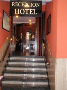 a staircase leading to a hotel with a sign on it at Favila Oviedo in Oviedo
