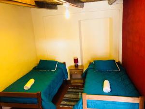 Ένα ή περισσότερα κρεβάτια σε δωμάτιο στο Hostal Intipara