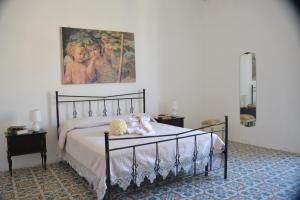 a bedroom with a bed with two teddy bears on it at Gocce Siciliane Apartments in Porto Empedocle