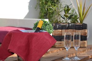 a table with wine glasses and a napkin at Gocce Siciliane Apartments in Porto Empedocle