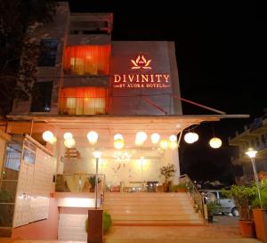 a restaurant with a sign on the front of it at night at Divinity by Audra Hotels in Mathura