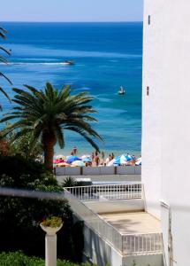 a view of the beach from the balcony of a resort at Sea Star Apartments - Casa Verde e Casa Azul in Armação de Pêra