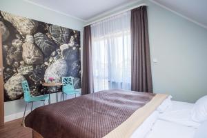 Łóżko lub łóżka w pokoju w obiekcie Dom Wypoczynkowy Simurg