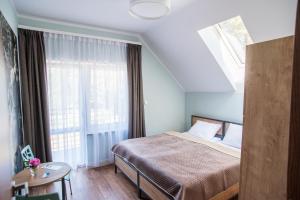 Łóżko lub łóżka w pokoju w obiekcie Dom Wypoczynkowy Simurg