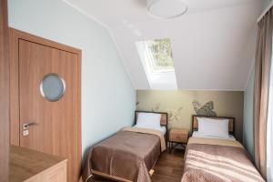 Łóżko lub łóżka w pokoju w obiekcie Dom Wypoczynkowy Simurg