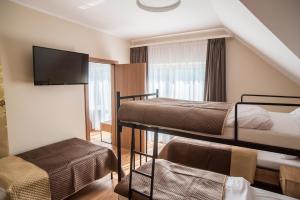 Łóżko lub łóżka w pokoju w obiekcie Dom Wypoczynkowy Simurg