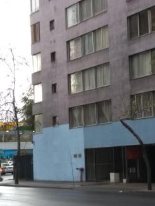 a building on the corner of a street at Kingui in Santiago