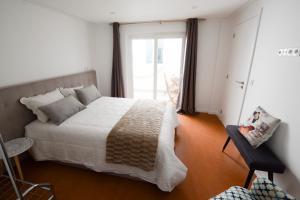 a bedroom with a large bed and a window at LUXURY Golden River Apartment - In the Heart of city center and wine cellars in Vila Nova de Gaia