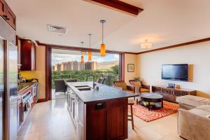 a kitchen and living room with a view of the city at Fifth Floor UPGRADED Villa with Sunset View - Beach Tower at Ko Olina Beach Villas Resort in Kapolei