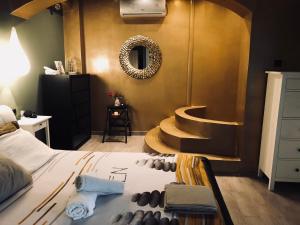 a bedroom with a bed with a sink and a mirror at Zoza Luxury villa isthmia by the sea with private pool in Kalamáki +36 photos