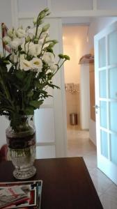 a vase filled with white flowers sitting on a table at Apartment Perica in Dubrovnik