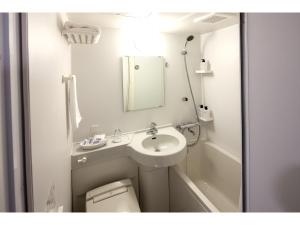 a bathroom with a sink, toilet, and shower at Y's Hotel Asahikawa Ekimae in Asahikawa