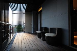 a room with chairs and a balcony with a window at 298Villa in Wujie