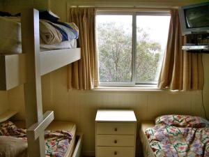 a small room with a bed and a window at Maisonette, Falls Creek in Falls Creek