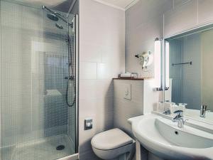 a bathroom with a shower and a sink and a toilet at Mercure Albi Bastides in Albi