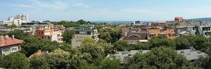 a group of buildings in a city with trees at Horizon Apartment in Varna City
