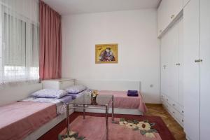 a room with two beds and a table in it at Horizon Apartment in Varna City