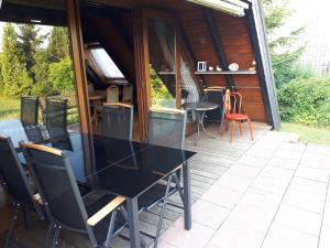 einen Tisch und Stühle auf einer Terrasse mit einem Haus in der Unterkunft Feriendorf Freilingen 151 A in Blankenheim