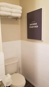 a bathroom with a toilet and towels on a shelf at Sweet 2-Bedroom Penthouse Apartment by Amazing Property Rentals in Gatineau +24 photos