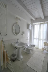 a bathroom with a sink and a toilet and a mirror at Angels'Home in Pizzo