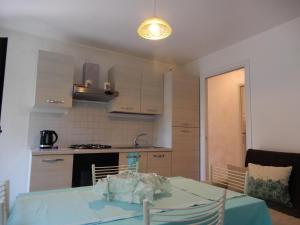 a kitchen with a table with a blue table cloth on it at casa vacanze luciano&son in Campobasso