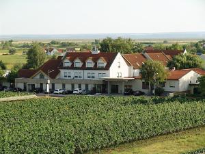 an aerial view of a house with cars parked in front at Hotel Nationalpark in Illmitz