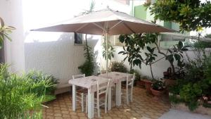 オートラントにあるHotel Agostinoの中庭の傘下のテーブルと椅子