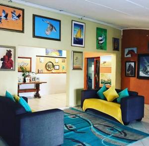 a living room with a bed and a couch at Hill Top Farm Lodge in Sea Park