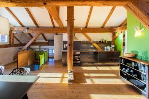 a large kitchen with wooden floors and wooden beams at Zeitraumferien in Bernau am Chiemsee