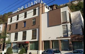 a hotel building with a sign on top of it at Hotel Liani in Lovech