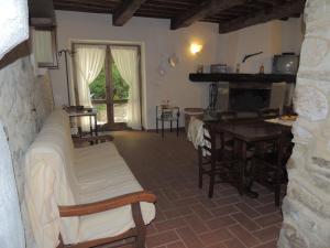 a living room with a table and a dining room at Agriturismo Molino del Ponte in Arcidosso