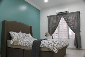 a bedroom with a bed and a window at Luxury Kuala Selangor Homestay in Kuala Selangor