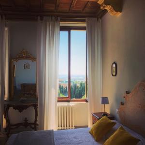 a bedroom with a bed and a large window at BnB Paolina in Siena