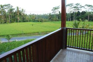 a balcony with a view of a rice field at Villa Kemuning in Tegalalang