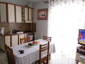een keuken met een tafel en een fruitschaal bij Apartament Joni in Golem