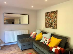 a living room with a couch and a mirror at Garden Oasis in Margate