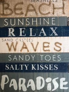 a group of signs on a wall with different names at Garden Oasis in Margate