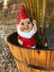 a gnome statue sitting in a planter at Garden Oasis in Margate