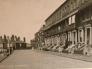 an old photo of a city street with buildings at Garden Oasis in Margate