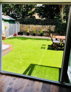 a view of a yard from a window of a backyard at Garden Oasis in Margate
