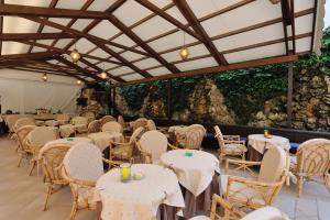 a row of tables and chairs in a tent at Hotel Salus in Lignano Sabbiadoro